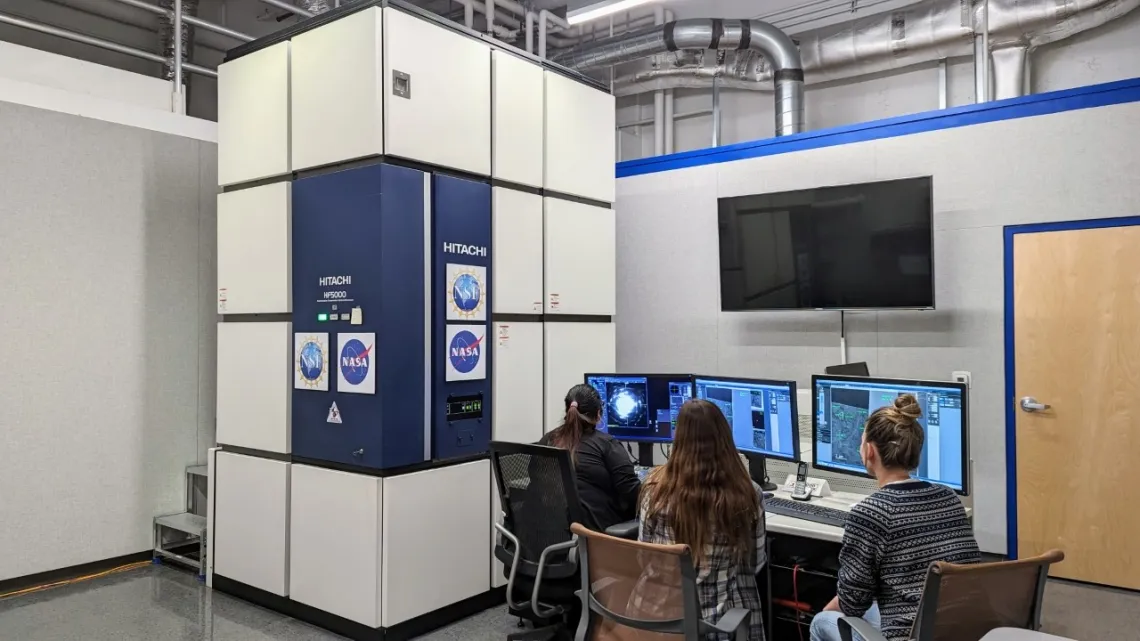 Students use the transmission electron microscope, or TEM, to study a meteorite sample at the KMICF